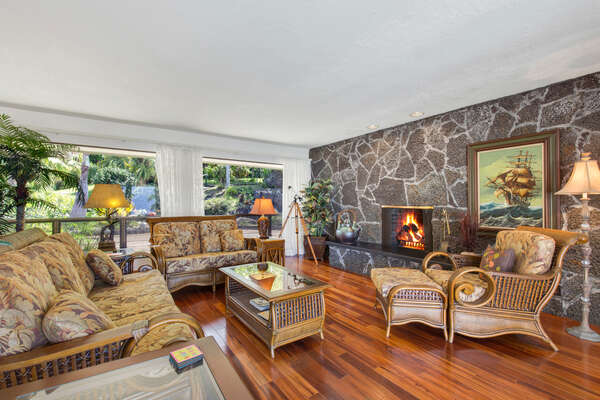 Living Area with multiple couches, lounge armchair, and coffee table in front of a fireplace.