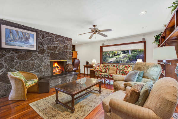 Entertainment Room with fireplace, ample seating, and an ornate stone wall.