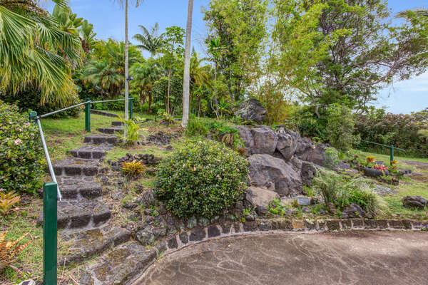 Stone stairs leading down to landscape features in this home.