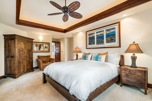 Bedroom with Large Bed, Armoire, Armchair, and Ceiling Fan