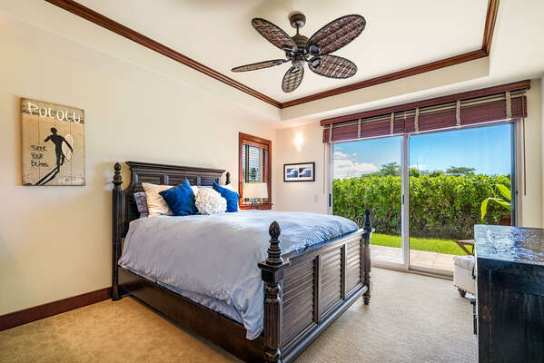 Bedroom with Private Lanai, Large Bed, Dresser, and Ceiling Fan