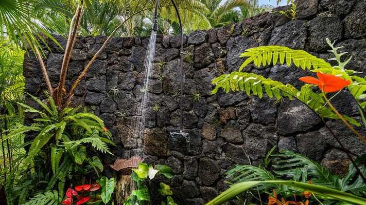 Outdoor Shower of this Kona Hawaii vacation rental, surrounded by local flora.