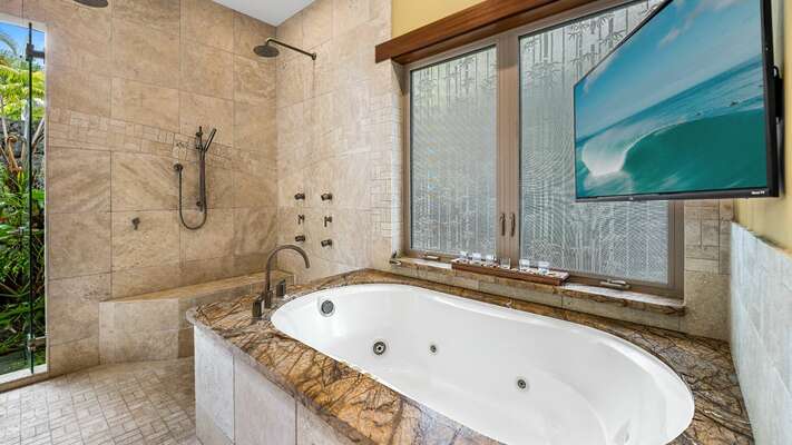 Primary Bathroom of this Kona Hawaii vacation rental with Soaking Tub and Flat Screen TV.