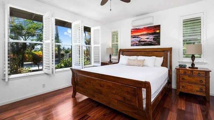 Primary Bedroom of this  Kona Hawaii vacation rental with Cal-King Bed and twin nightstands.