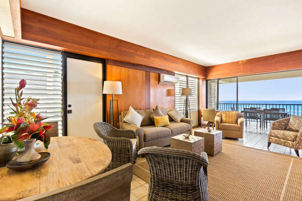 Living Area with multiple seating options and a large glass door to the lanai.