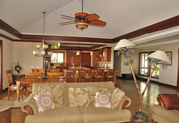 Sofa, Ceiling Fan, Dining Table, Chairs and the Kitchen