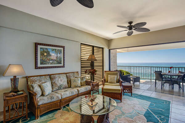 Living Area of this Kona Hawaii vacation rental with couch and glass top coffee table.
