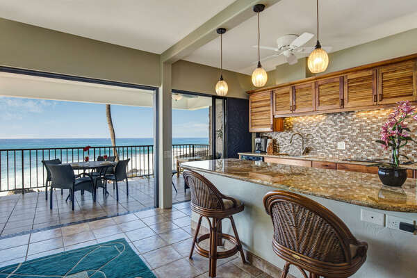 Kitchen of this Kona Hawaii vacation rental with bar seating and a view outside.