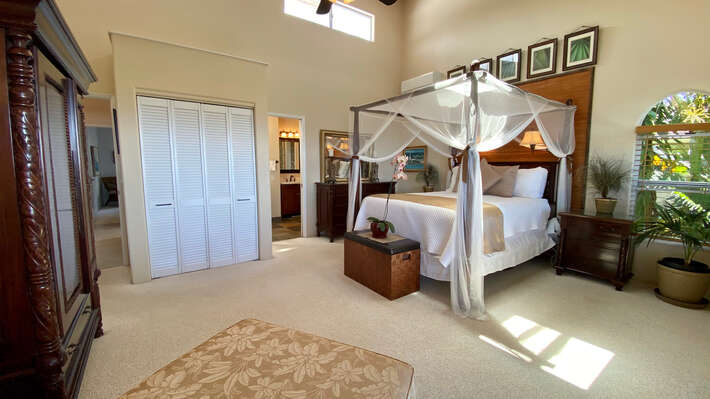 Bedroom with Large Bed, Closet, Ceiling Fan, and an Armoire