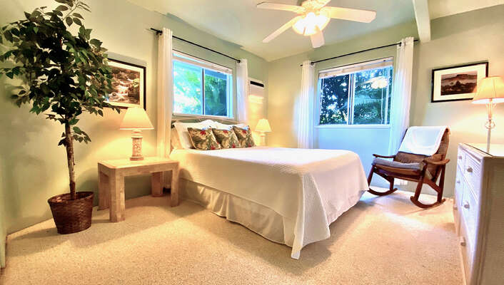 Bedroom with Large Bed, Ceiling Fan, and Rocking Chair