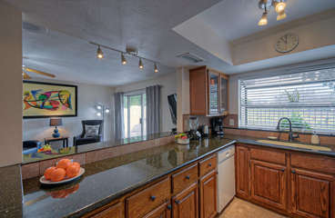 Remodeled kitchen complete with granite counter tops opens to great room and eating area.