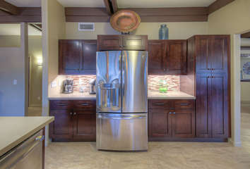 Designer kitchen boasts granite counters, stainless steel appliances and beautiful tile floors.