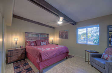 King bed, TV, ceiling fan and ensuite bath are appreciable features of the east primary suite.