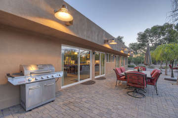 Cheers for outdoor dining on large private patio in sunny and chic Scottsdale.