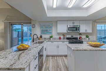 Well stocked newly remodeled kitchen makes it easy to prep and serve delicious cuisine.