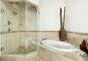 Grand Master Bathroom with jetted tub, dual sinks, and glass shower