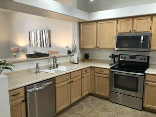 Remodeled kitchen is completely stocked for ease in preparing and serving meals.