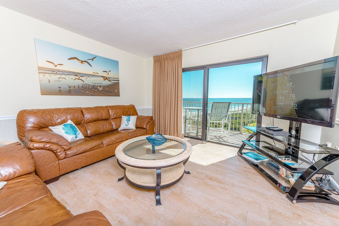 Cozy living room with natural light and a view of the balcony