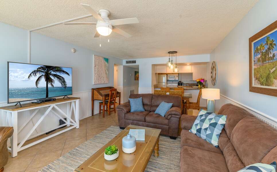 A spacious living and kitchen area with a cozy atmosphere, perfect for entertaining or relaxing after a day at the beach.