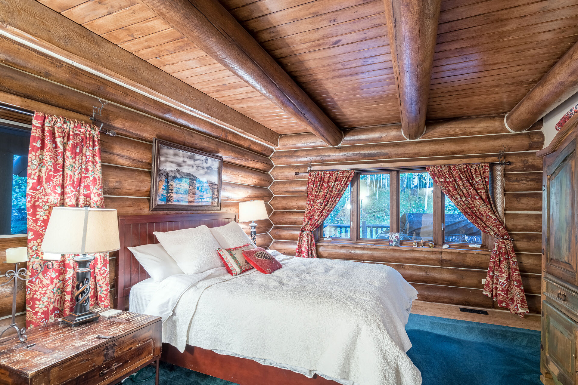 Bedroom with Wooden Logs and Views of Outside