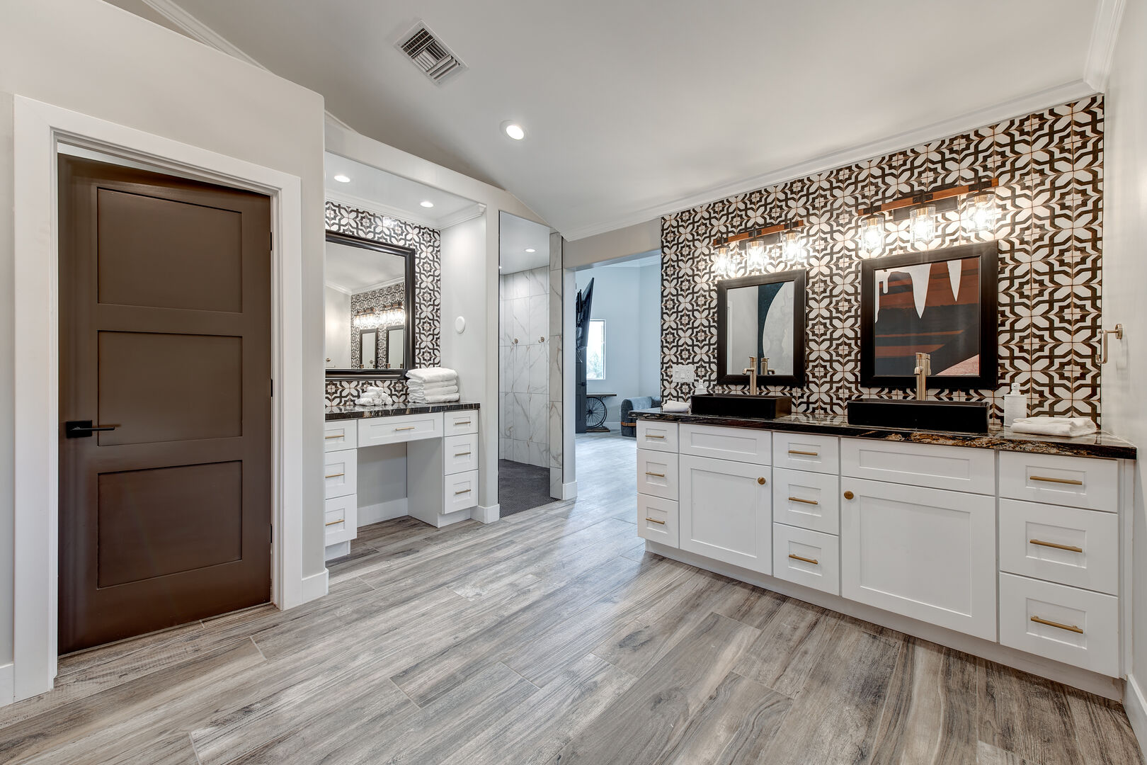 Master Bathroom with large walk-in closet with walk in shower, soaker tub, dual vanity and makeup counter.