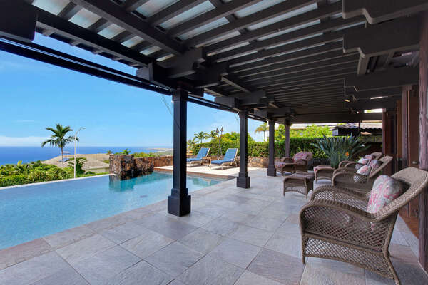 This Kona vacation home rental features a covered lanai overlooking Infinity Pool.