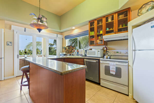 Fully Equipped Kitchen with modern amenities and chairs by the breakfast bar.