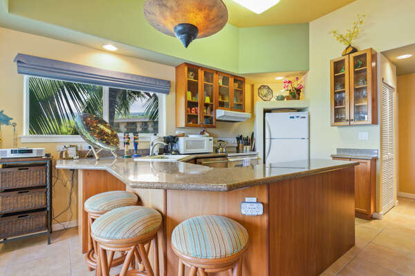 Kitchen area with breakfast bar and seating for 3.