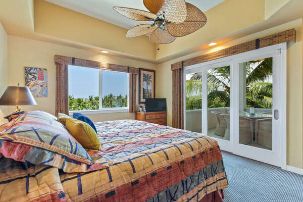 Primary Bedroom with King Bed facing large doors to the private Lanai.