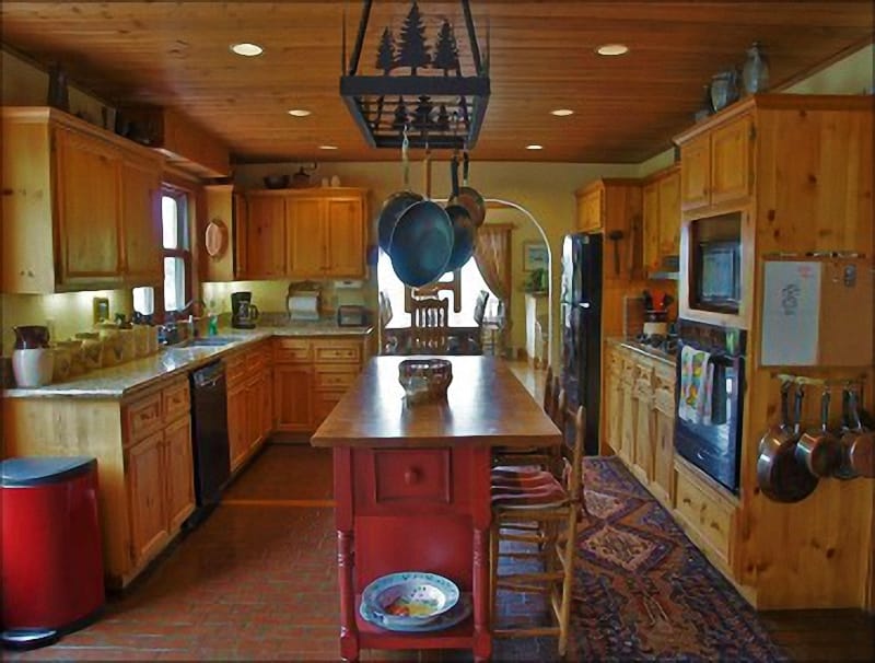 A very open Kitchen with Granite Counters, Gas Range & Butcher Block Island.