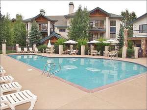 Heated Pool & Hot Tub area with sunbathing chairs & picnic tables.