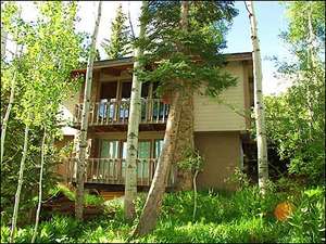 This family home is nestled in the trees and features ski in/ski out location