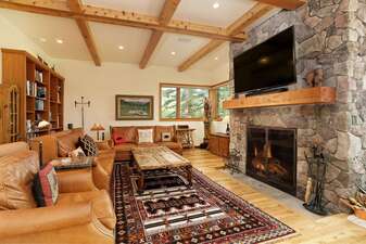 Cozy Living Room with Wood Burning Fireplace and Large Screen TV