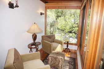 Seating for 2 in enclosed patio with views of the Roaring Fork River