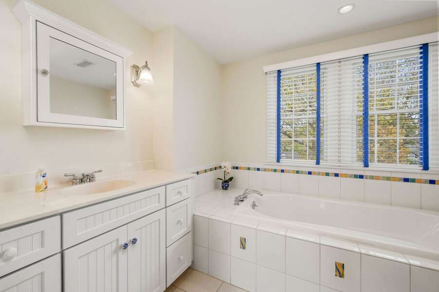 Bathroom located off of the hallway with a shower and tub. On the 2nd floor - 24 Sea Mist Lane Chatham Cape Cod New England Vacation Rentals