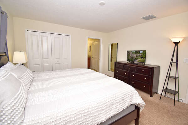 Master bedroom showing TV and bathroom