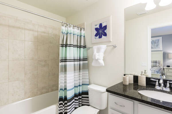 En suite bathroom with combination shower/bathtub