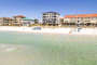 Photo of the beach near this Destin Beachfront Vacation Home, with it visible in the distance.