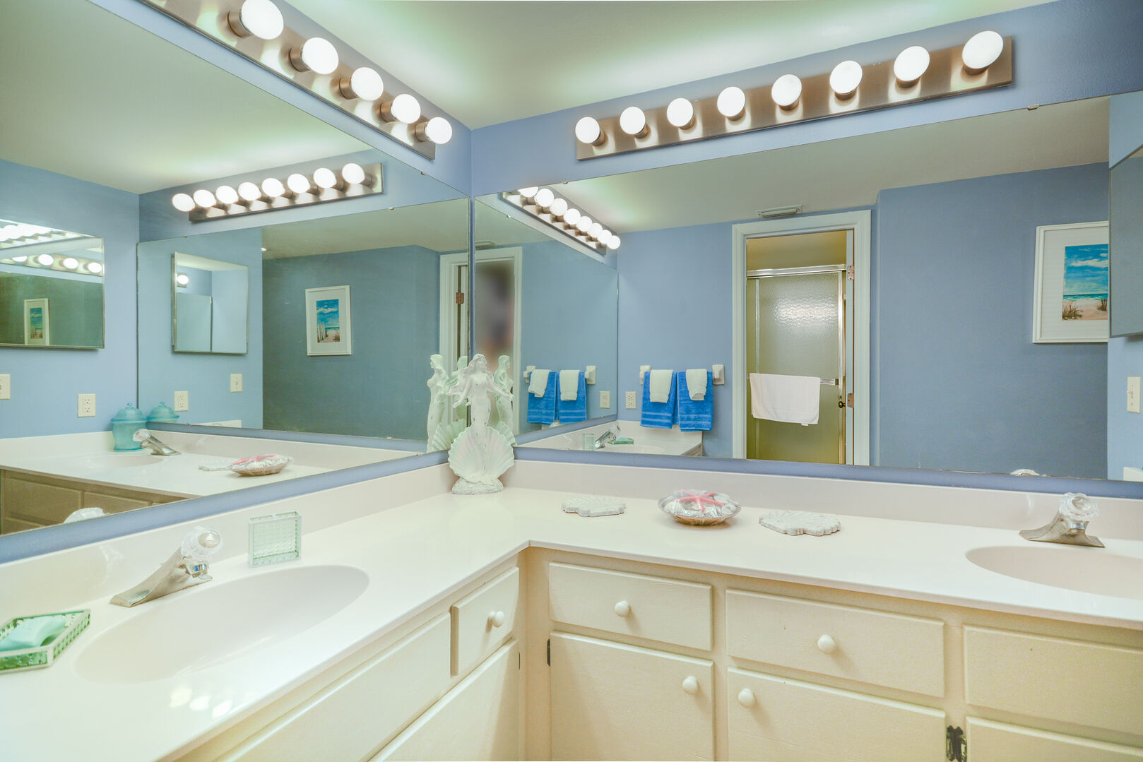 Master bath with double sinks and vanity mirrors.