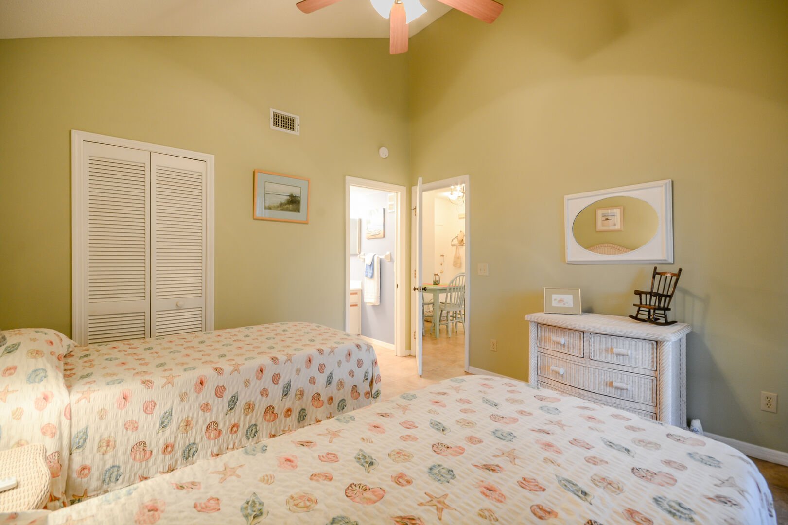 The guest bedroom of this vacation rental in New Smyrna Beach FL, with two beds.
