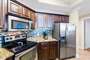 The Fully Equipped, Spacious Kitchen has Stainless Steel Appliances and Granite Counter Tops