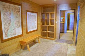 Entry with gear storage, bench, coat racks, and maps for planning your adventures