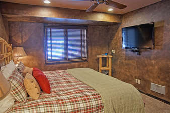 Bedroom 2 also has a large HDTV and ceiling fan