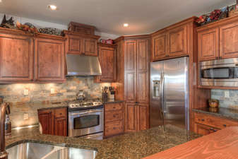 Gas range, granite counters, and stainless steel appliances