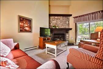 Living Room Boasts a Flat Screen TV and Gas Fireplace