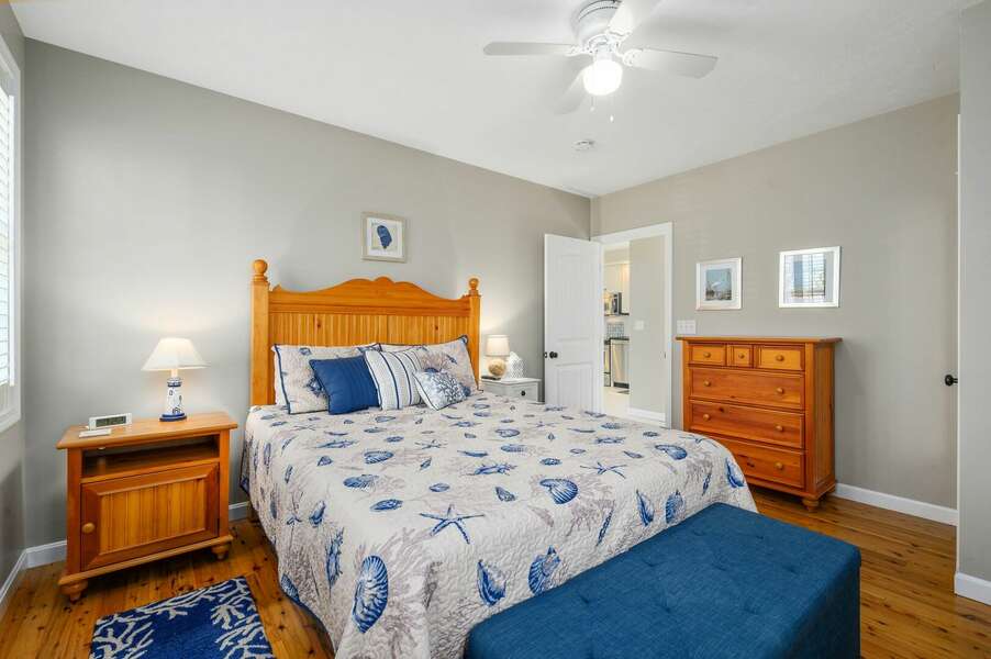 Queen-sized bedroom on main level located between living space and entry hallway - 9 Wilfin Road South Yarmouth Cape Cod - Four Shore - NEVR