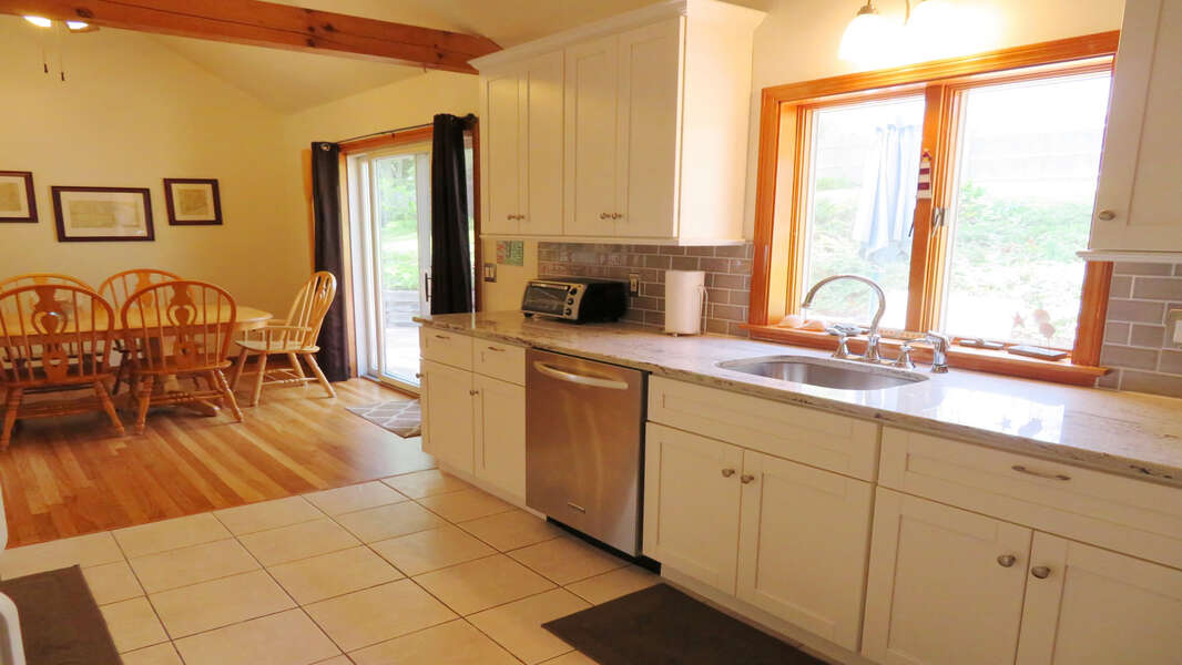 Sliders of dining and kitchen area to deck make for easy barbecuing!  180 Hardings Beach Road Chatham Cape Cod - New England Vacation Rentals