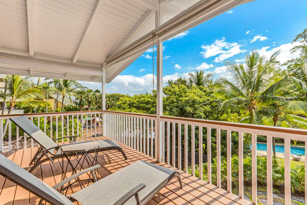 Lanai off Upper level Primary Bedroom of this Kona Hawaii vacation rental with two lounge chairs.
