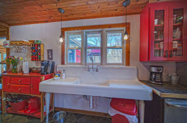 Image of Sink and Red Cabinets.