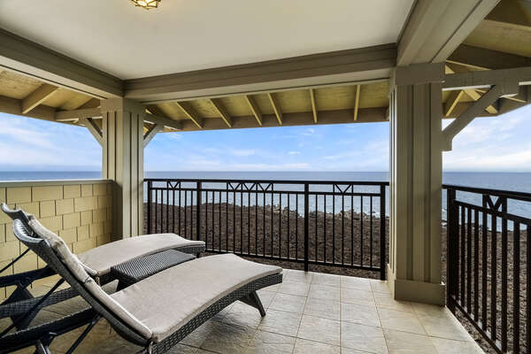 Upstairs Main en-suite lanai of this Kona Hawaii vacation rental with two cushioned lounges.